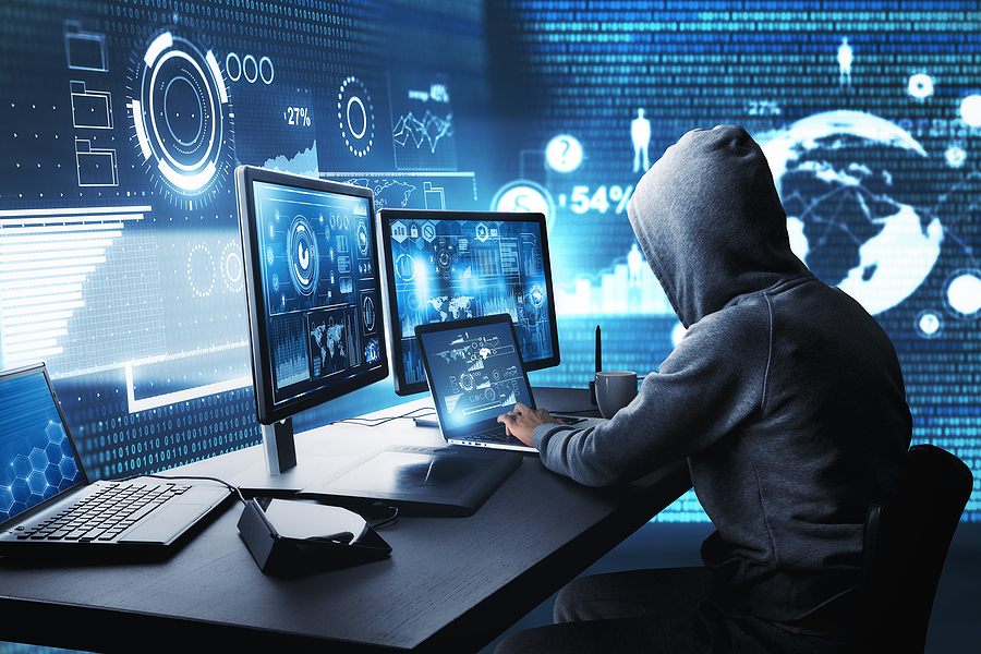bigstock-Side-View-Of-Hacker-Using-Comp-253465240